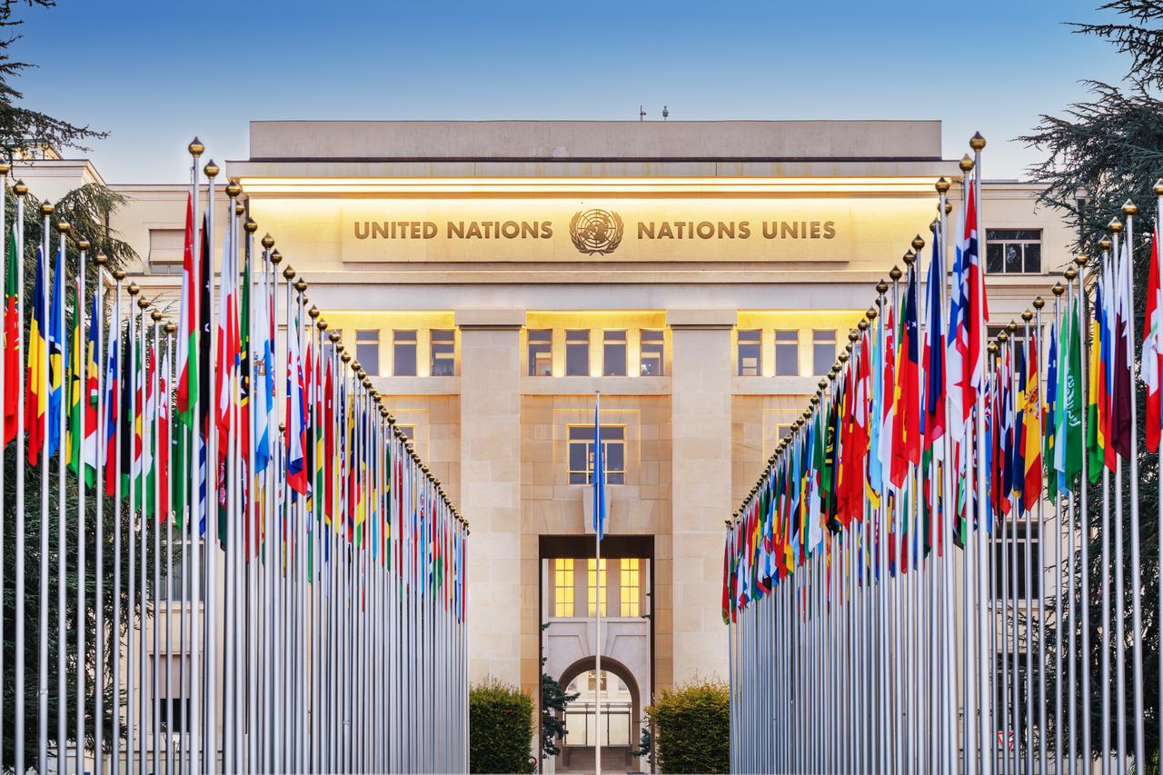 Flags of U.N. member states line the entrance to the Palais des Nations, the United Nations Office at Geneva, Switzerland, undated. (Adobe Stock Photo)