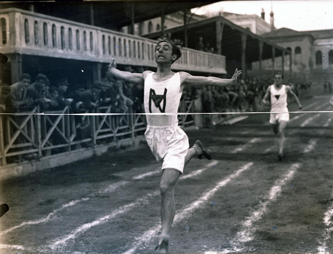 A runner crosses the finish line during a track and field competition in Istanbul in the 1930s. (Photo via Pera Museum)