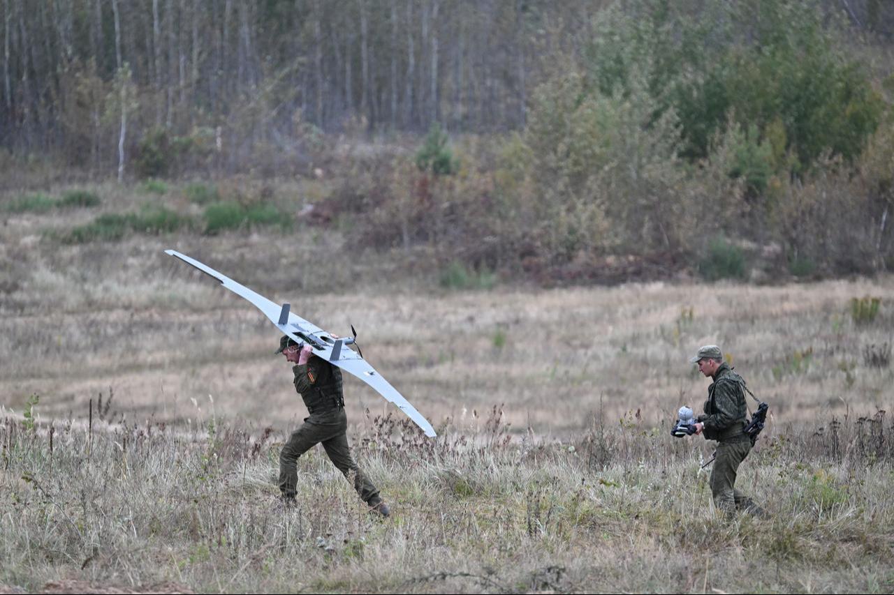 A Belarus' serviceman carries an unmanned aerial vehicle (UAV) during the "Zapad-2025" (West-2025) joint Russian-Belarusian military drills in Borisov, east of the capital Minsk, Sept. 15, 2025. (AFP Photo)
