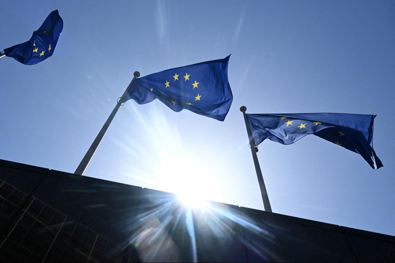 A photograph taken on May 28, 2026 shows the European flags flapping in the breeze in outside the EU headquarters in Brussels. (AFP Photo)