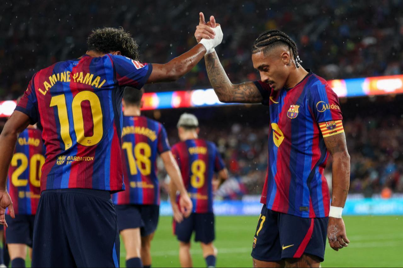 Barcelona's Brazilian forward #11 Raphinha celebrates scoring his team's second goal from the penalty spot with Barcelona's Spanish forward #10 Lamine Yamal during the Spanish league football match between FC Barcelona and Racing Santander at the Camp Nou stadium in Barcelona on September 16, 2026. (AFP Photo)