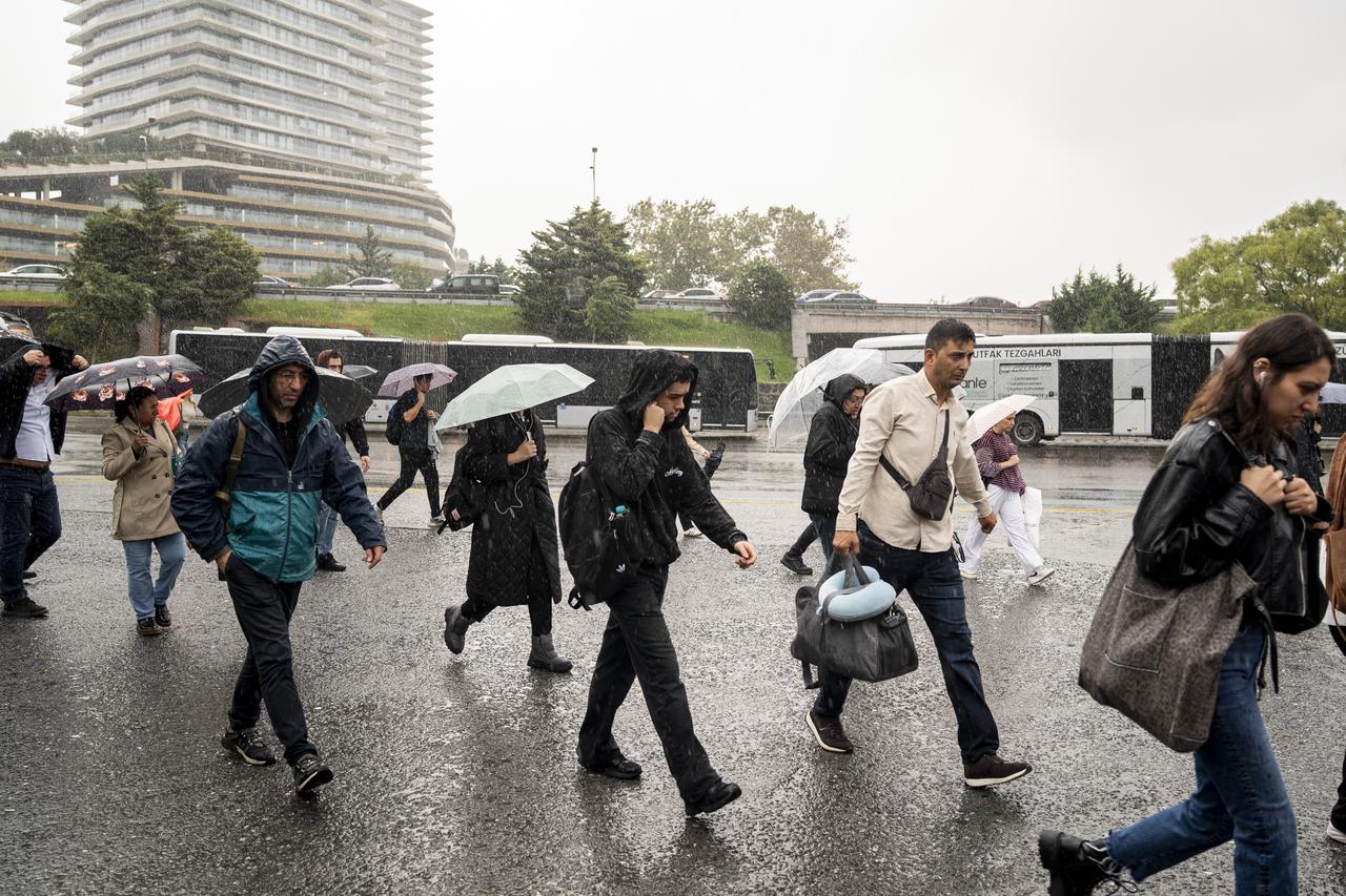 Commuters walk through heavy rain during the morning rush hour in Istanbul, Türkiye, Sept. 28, 2026. (AA Photo)
