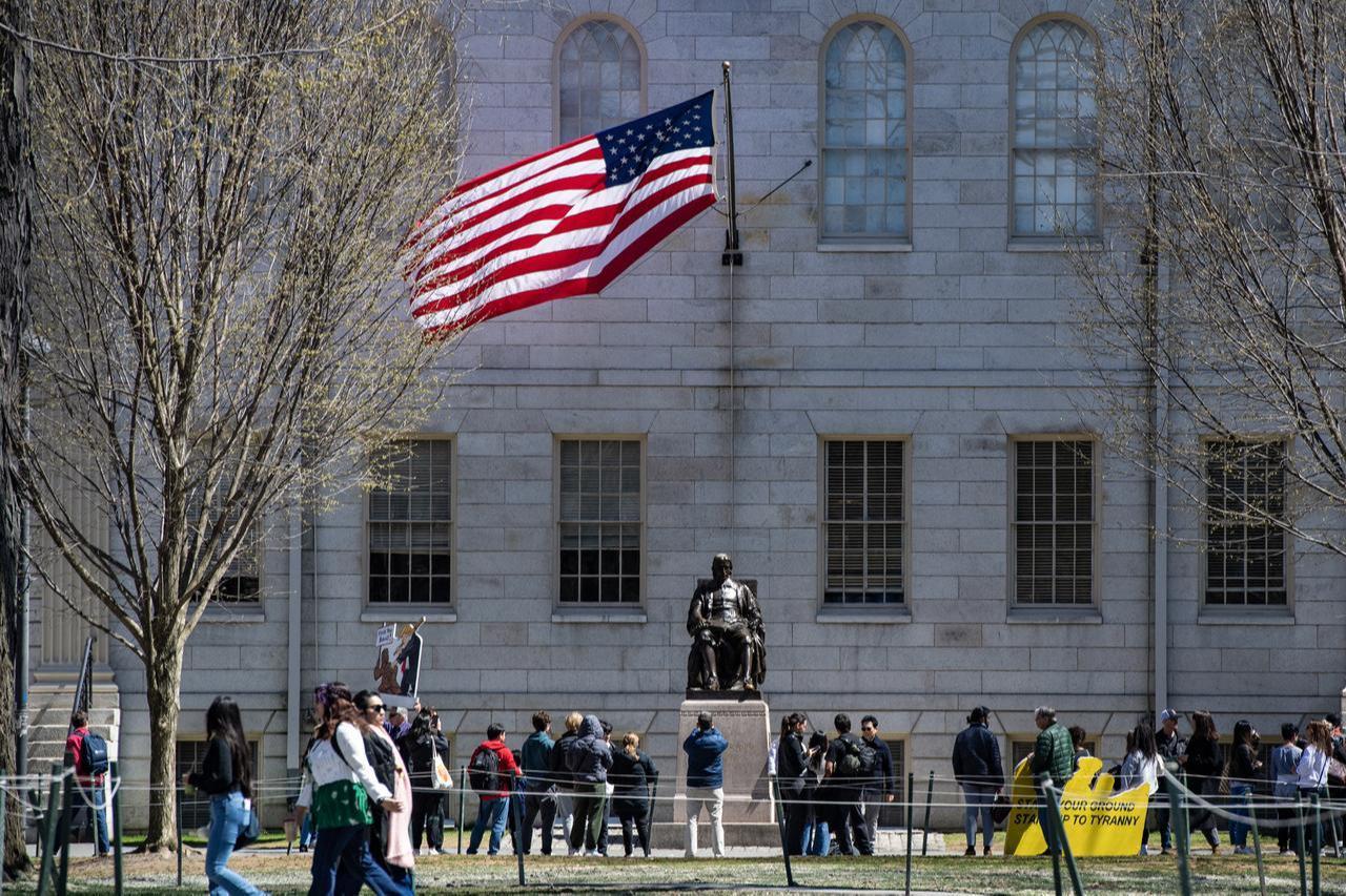 Demonstrators with signs stand around the John Harvard Statue in Harvard Yard following a rally against President Donald Trump’s attacks on Harvard University at Harvard University in Cambridge, Massachusetts, US on April 17, 2025. (AFP Photo)