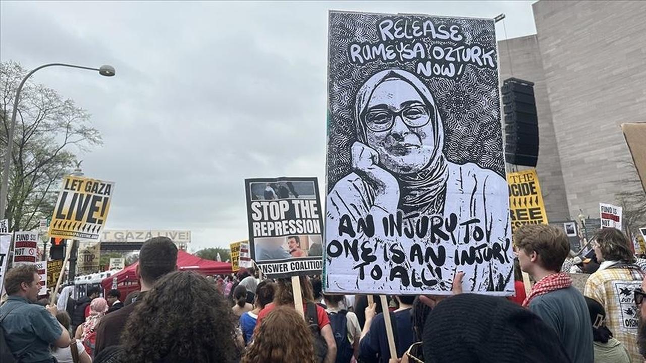 A protester at the Gaza march in Washington holds a photo of Turkish Tufts University student Rumeysa Ozturk, with a sign that reads: 'An injury to one is an injury to all,' in Washington, U.S. on April 5, 2025. (AA Photo)
