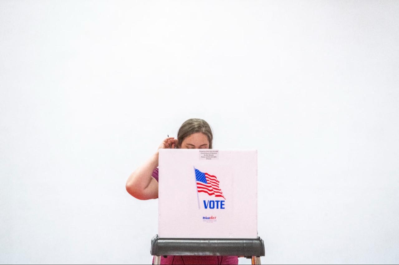 A woman scratches her head as she casts her ballot during the Maryland state primary election at a polling station in Annapolis, Maryland, on May 14, 2024. (AFP Photo)