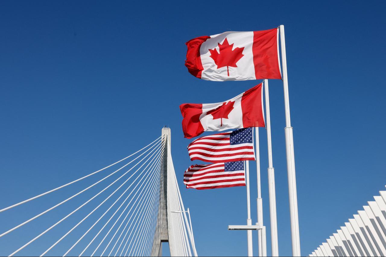 Flags of Canada and United States fly across the international border on the Gordie Howe International bridge that connects Windsor, Ontario, Canada and Detroit, Michigan on September 6, 2026. (AFP Photo)