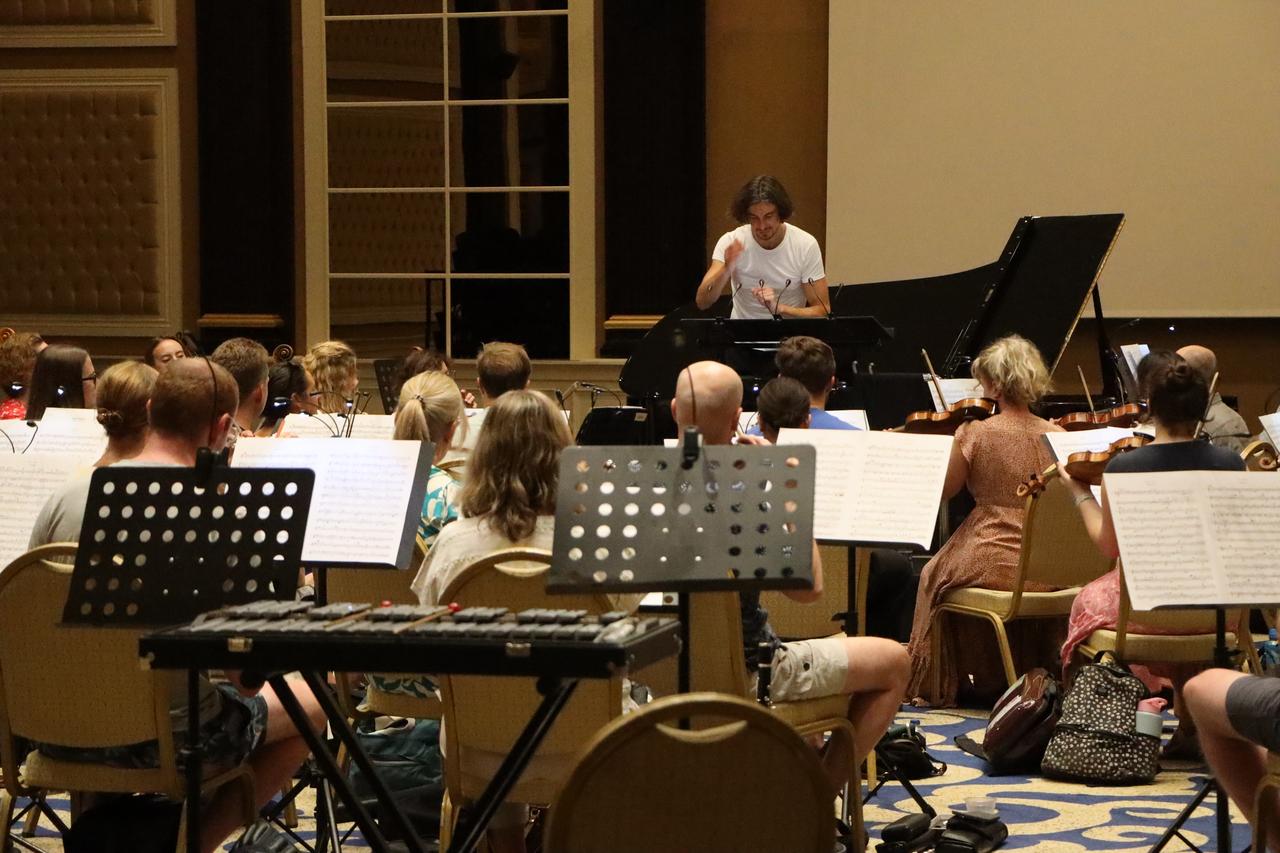 A conductor leads the Covent Garden Sinfonietta during a rehearsal ahead of the ensemble’s first concert in Türkiye, in Bodrum, Mugla, Sept. 3, 2026. (AA Photo)