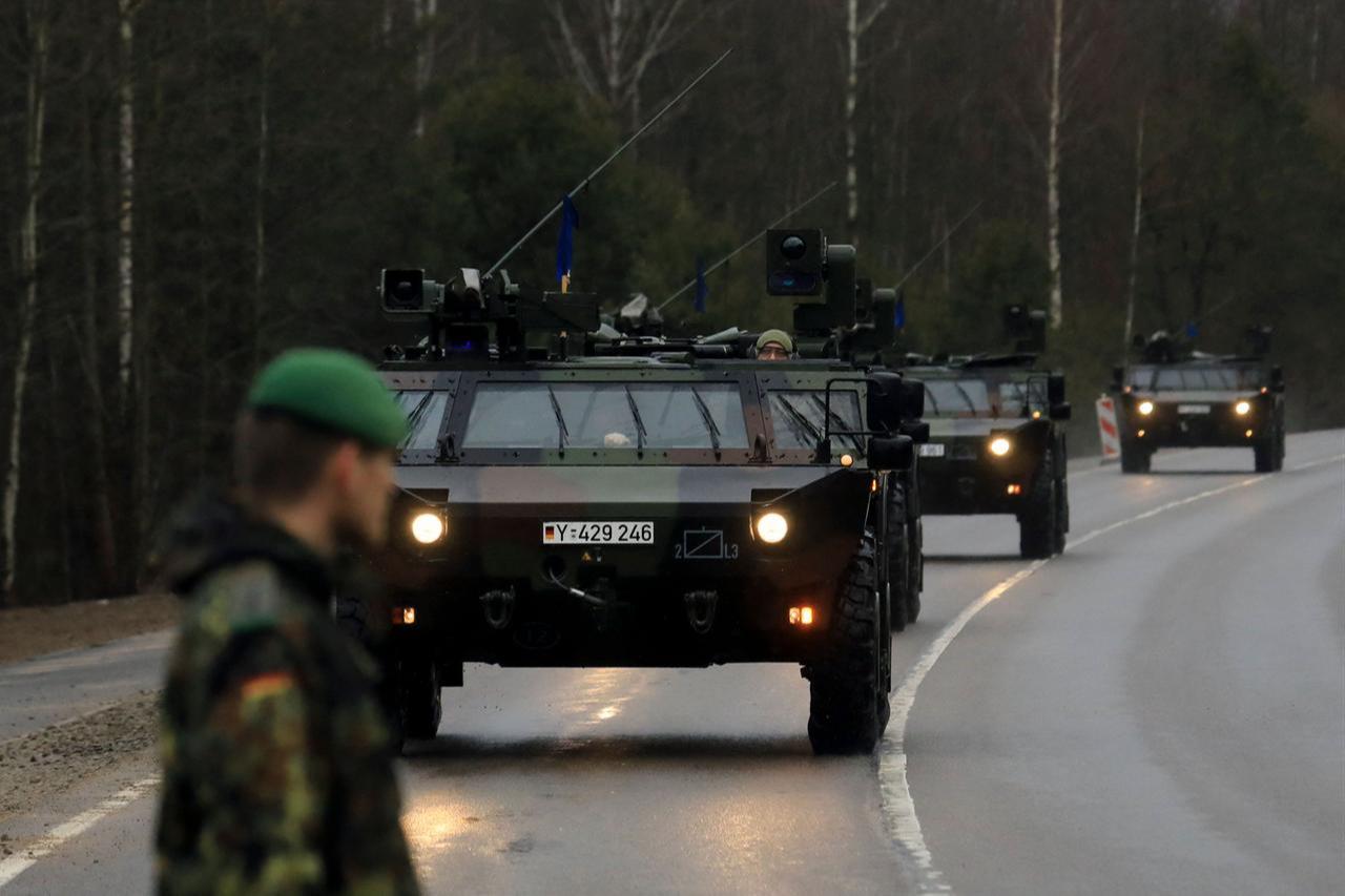 A convoy of armoured vehicles of German armed forces Bundeswehr arrives at the NATO enhanced Forward Presence Battle Group Battalion in Rukla, Lithuania, February 17, 2022. (AFP Photo)