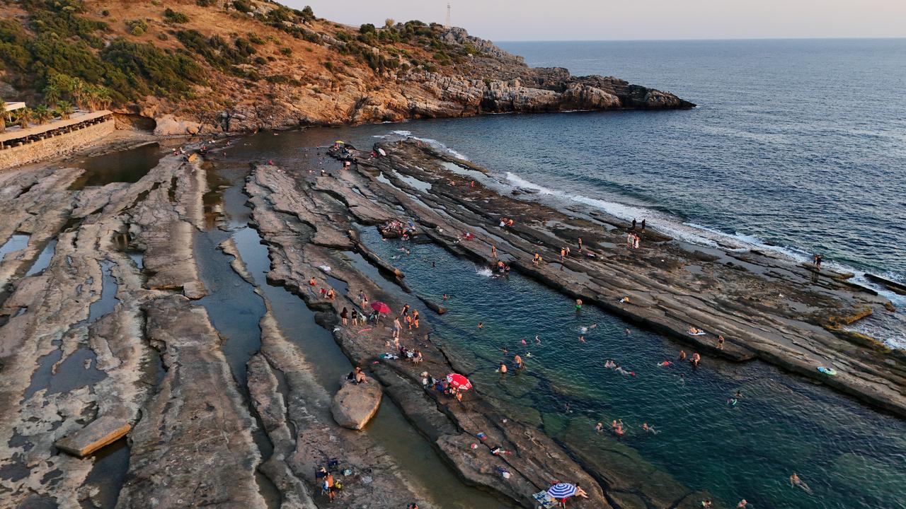 Dragon-like rock skin cradles natural pools in Antalya