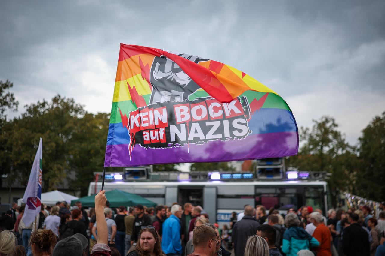 A participant in a counter-demonstration against the far-right AfD is waves a flag that reads "Fed up with Nazis" in Haldensleben, eastern Germany on September 1, 2026. (AFP Photo)