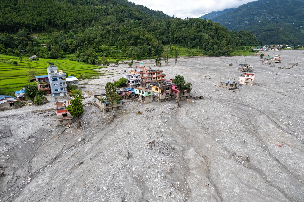 An aerial view shows homes and farmland surrounded by flood debris along the Trishuli River in Nepal, Sept. 3, 2026. (AA Photo)