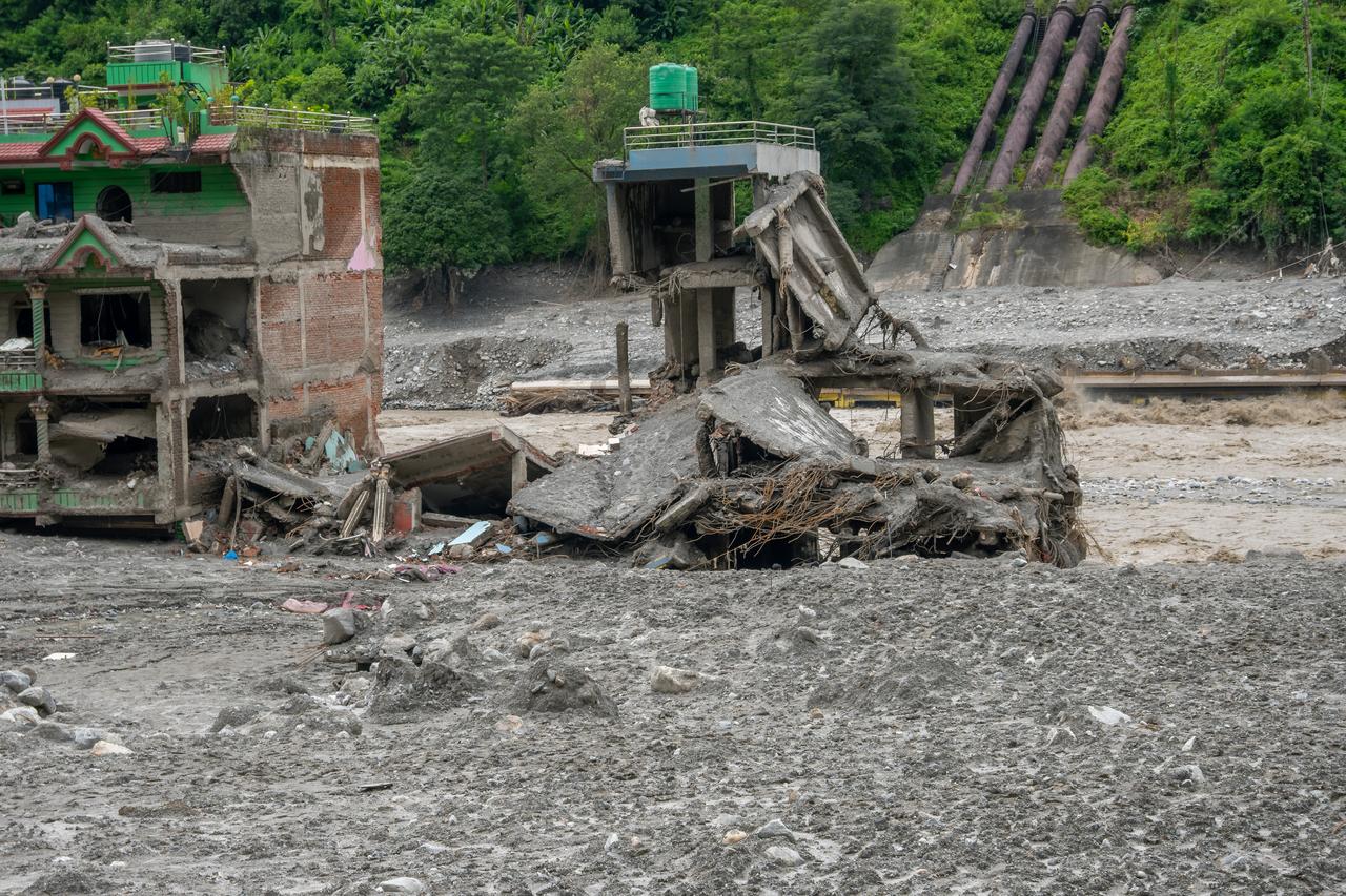 Flood-damaged buildings stand amid mud and debris along the Trishuli River in Nepal, Sept. 3, 2026. (AA Photo)