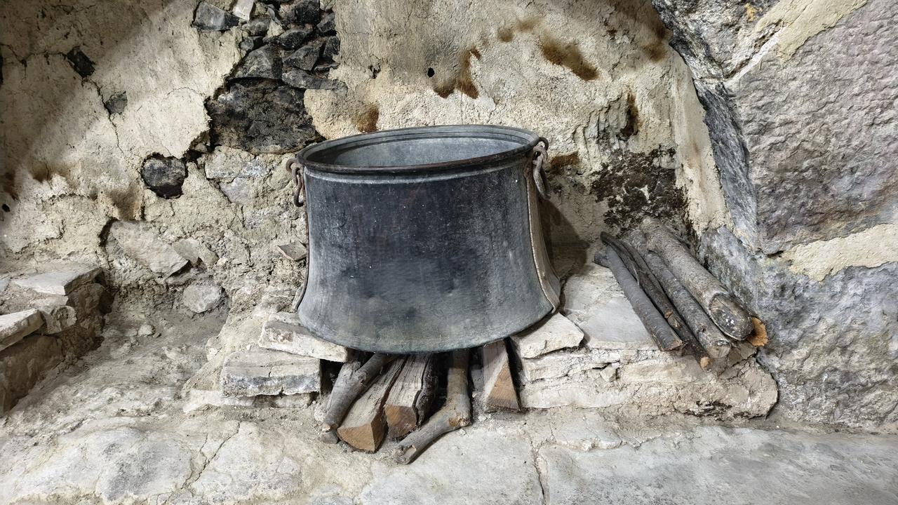 A traditional metal cauldron and firewood are displayed in one of the hearth areas of Safranbolu's centuries-old laundry house. (AA Photo)