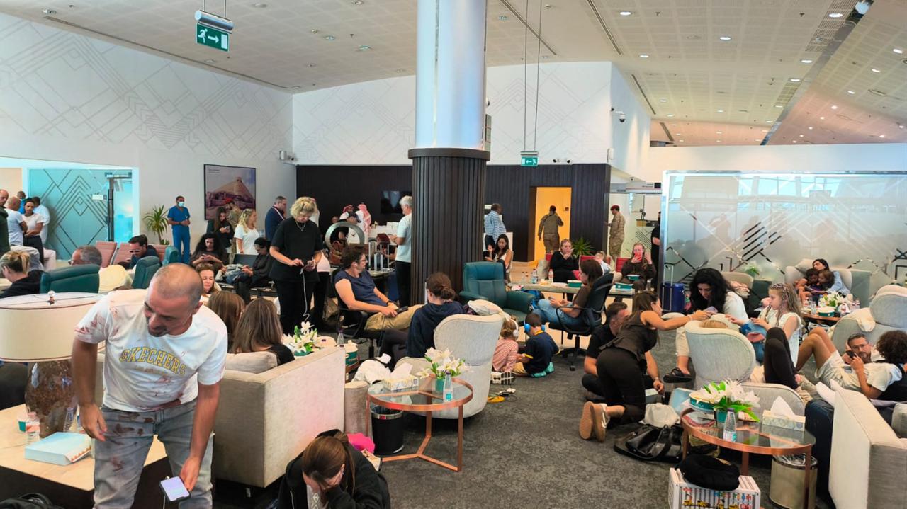In this handout picture taken and obtained on September 30, 2026, passengers of the flydubai flight FZ 1073 from Dubai to Tel Aviv are seen inside the Prince Sultan bin Abdulaziz Airport in Tabuk, after their plane was forced to land in Saudi Arabia. (Photo by Courtesy Of An Anonymous Source / AFP)