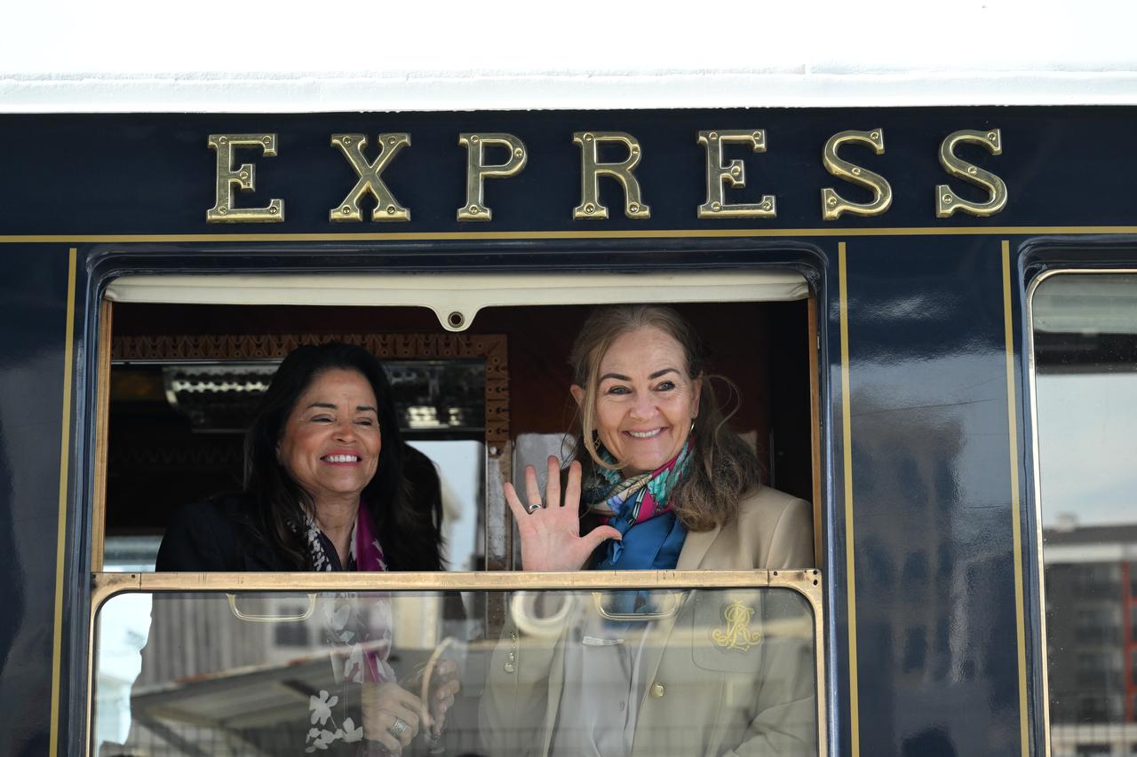 Passengers on the historic Venice Simplon-Orient-Express wave from a carriage window as the train arrives on its second trip of the year. (AA Photo)