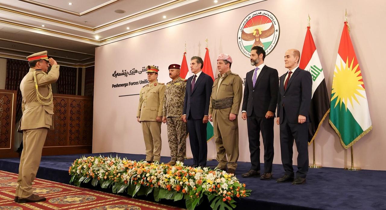 The image shows a ceremony in Erbil on September 21, 2026, marking the official unification of the Peshmerga forces under the Ministry of Peshmerga Affairs, an event attended by the Kurdistan Regional Government (KRG) of Iraq President Nechirvan Barzani, Prime Minister Masrour Barzani and Deputy Prime Minister Qubad Talabani alongside senior military commanders. (Photo via X)