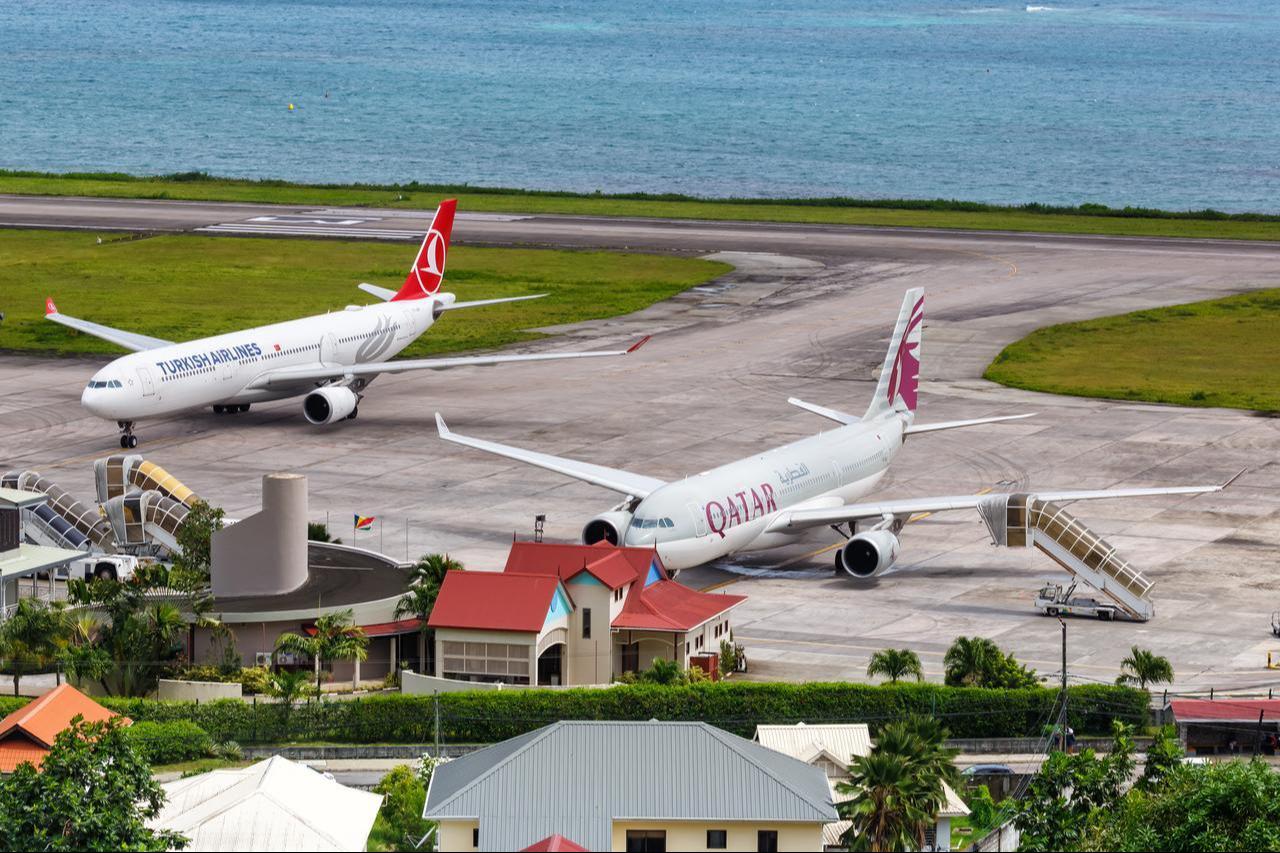 Qatar Airways and Turkish Airlines Airbus A330 aircraft are pictured at Mahe Airport in Mahe, Seychelles, Feb. 3, 2020. (Adobe Stock Photo)