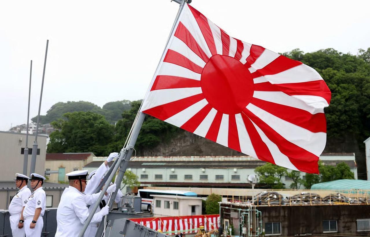Members of the Japan Maritime Self-Defence Force raise the naval ensign aboard the Mogami-class JS Natori at the Mitsubishi Heavy Industries shipyard in Nagasaki on May 21. (AFP Photo)