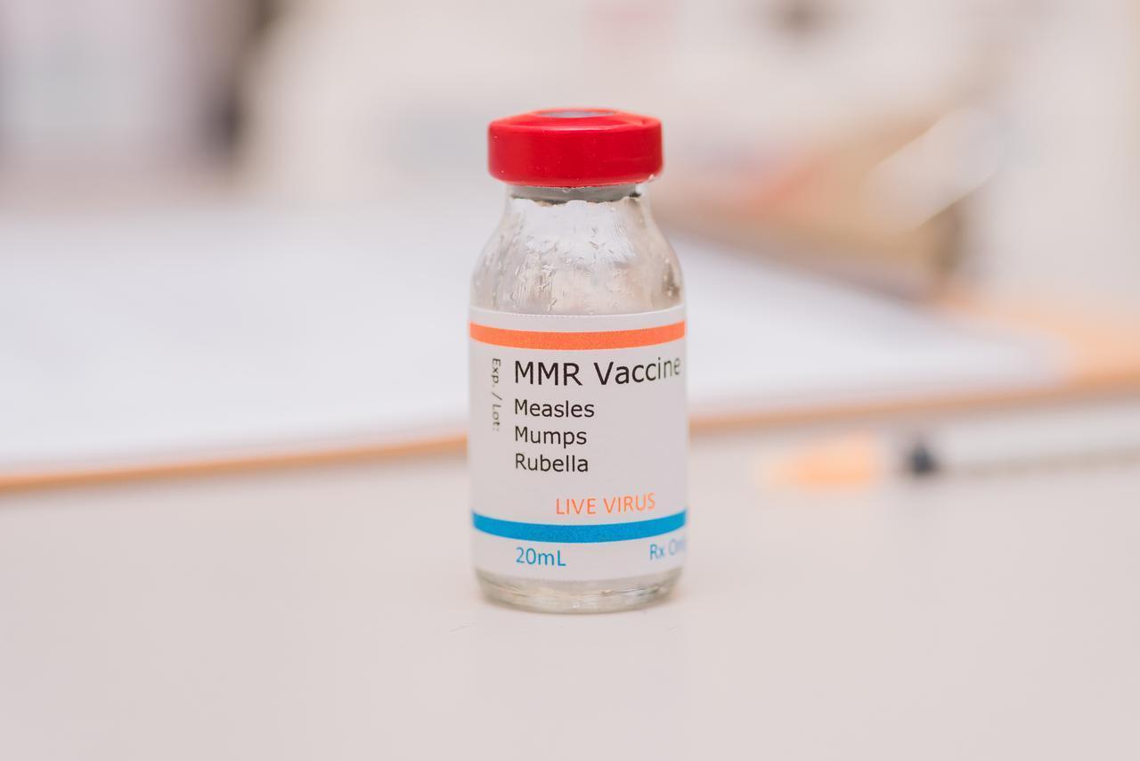 A vial labeled as an MMR vaccine for measles, mumps and rubella sits on a counter. (Envato Stock Photo)