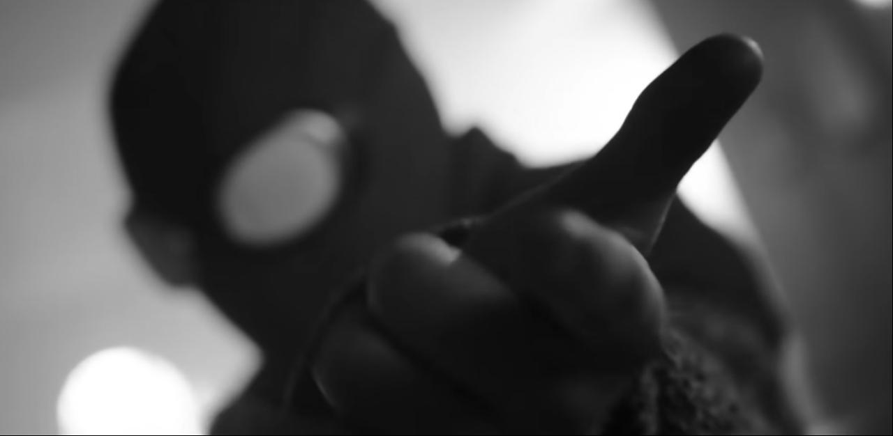 A masked character reaches toward the camera in a black-and-white scene from the “Spider-Noir” trailer ahead of its May 27 premiere on Prime Video. (Photo via Prime Video)