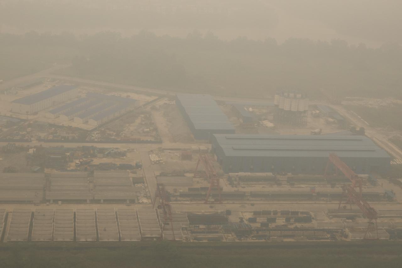Aerial photo shows thick haze from Indonesian forest fires obscuring an industrial site in Kuching, the capital city of Malaysia's Sarawak state on the island of Borneo, on Sept. 5, 2026. (AFP Photo)