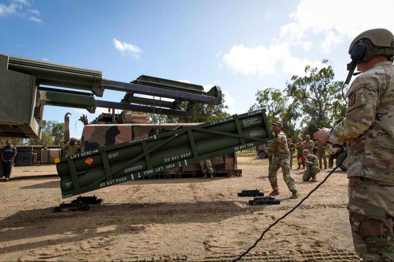 U.S. Army service member prepares the crane for loading the Army Tactical Missile System (ATACMS) onto the High Mobility Artillery Rocket System (HIMARS) in support of Talisman Saber 2023 at Williamson Airfield in Queensland, Australia, July 26, 2023. (Photo via U.S. Army)