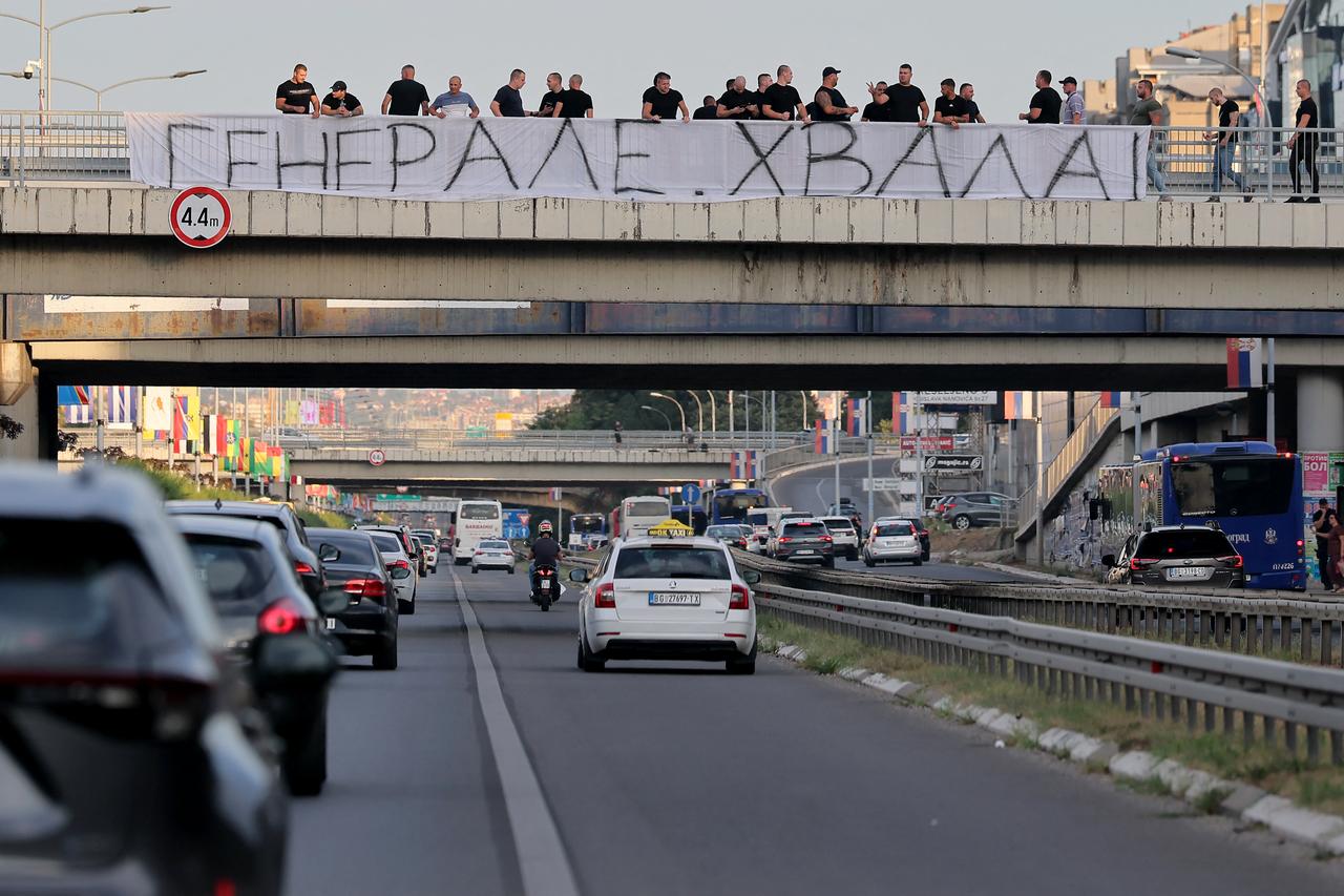 A group of people gathered on a footbridge over a motorway hold a banner reading "Thank you general" as they greet a convoy carrying the body of Bosnian Serb war criminal Ratko Mladic as it passes through Belgrade, Serbia, on September 3, 2026. (AFP Photo)