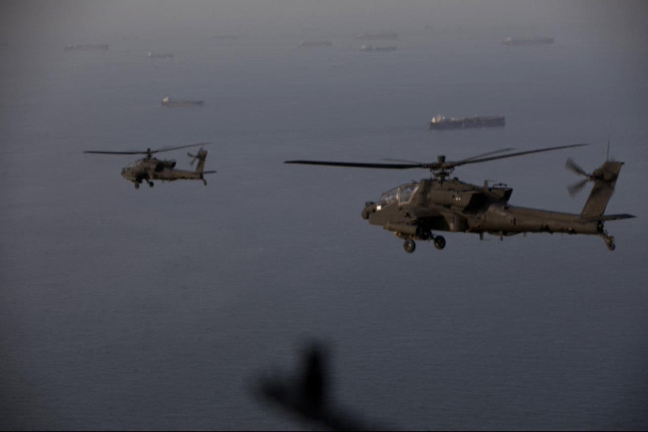 This handout photo released by US Central Command via their X account (@CENTCOM) on April 18, 2026 shows AH-64 Apaches flying above the Strait of Hormuz during a patrol, April 17, 2026.(AFP Photo)