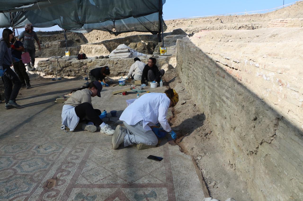Archaeologists carry out excavation and conservation work on the fourth-century floor mosaics uncovered in the central nave of the basilica at Pompeiopolis. (Photo via Ministry of Culture and Tourism)