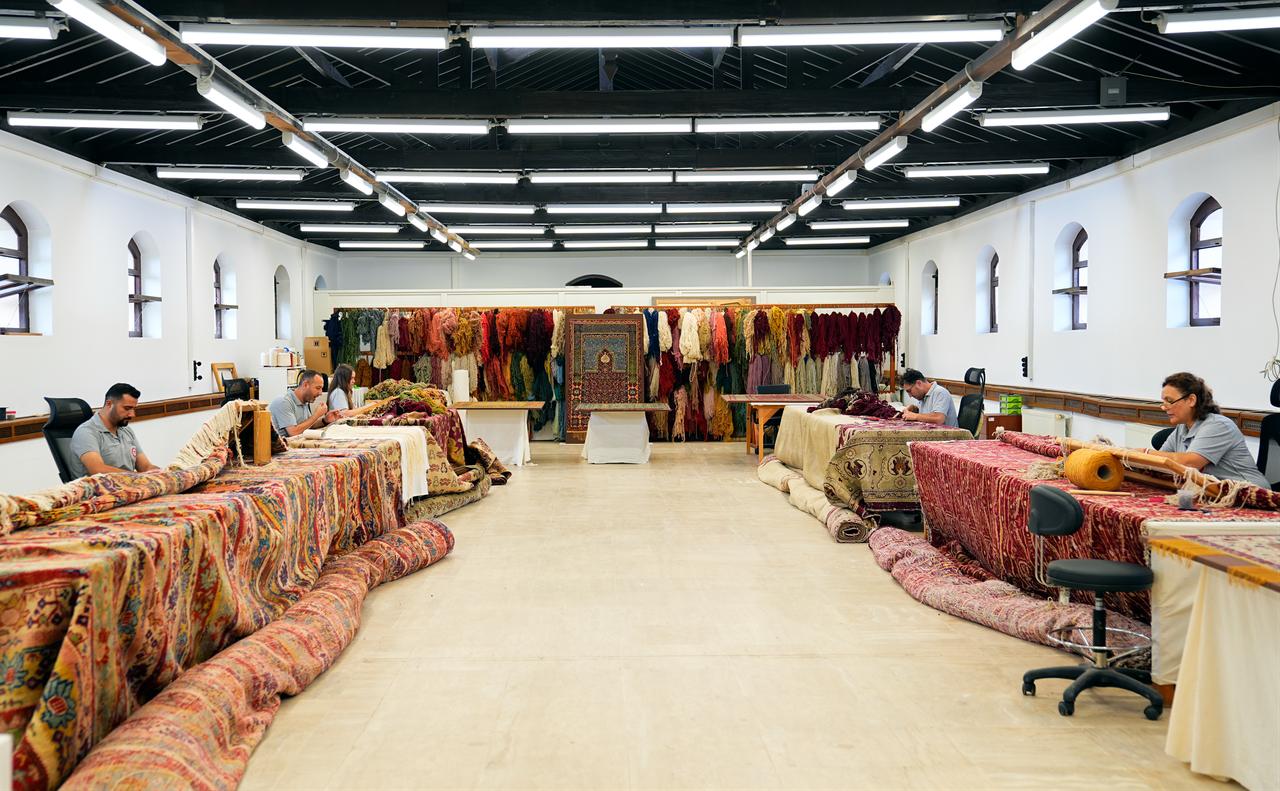 Specialists work on historic carpets and prayer rugs at the National Palaces Carpet Restoration and Conservation Workshop in Istanbul, Türkiye. (AA Photo)