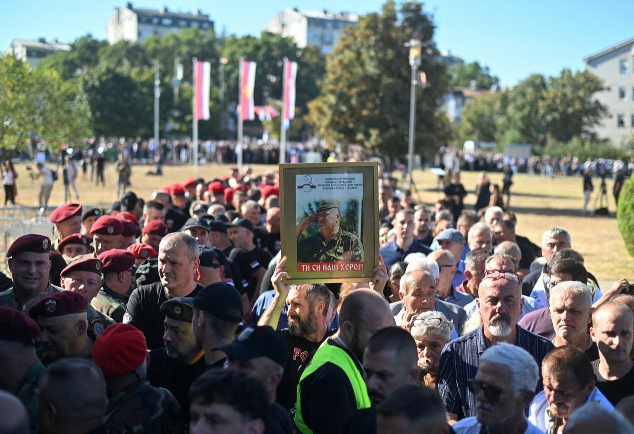 People, holding a portrait of war criminal Ratko Mladic, queue as they arrive to take part in a public memorial on the day of his funeral ceremony at St Lukas church in Belgrade, on September 7, 2026. (AFP Photo)