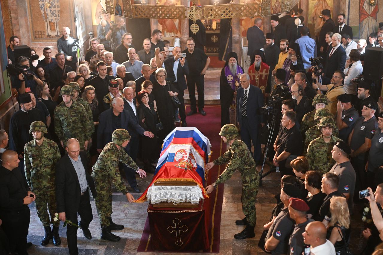 People gather around the coffin of war criminal Ratko Mladic at the end of a funeral ceremony at St Lukas church in Belgrade on September 7, 2026. (AFP Photo)