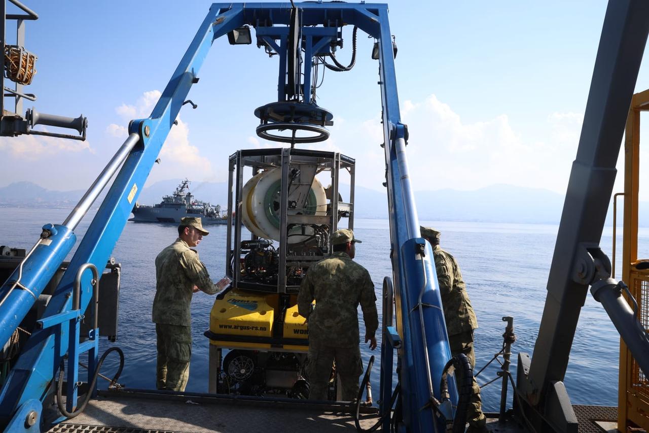 Turkish Naval Forces personnel prepare an underwater search vehicle during operations to locate people missing after the vessel capsized off Girne in Turkish Cyprus. (AA Photo)