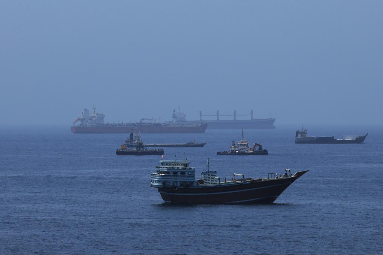 A view of commercial cargo vessels and crude oil tankers are anchored in the Gulf of Oman, off the coast of Muscat, Oman, on June 21, 2026, as they prepare to transit through the critical Strait of Hormuz. (AA Photo)