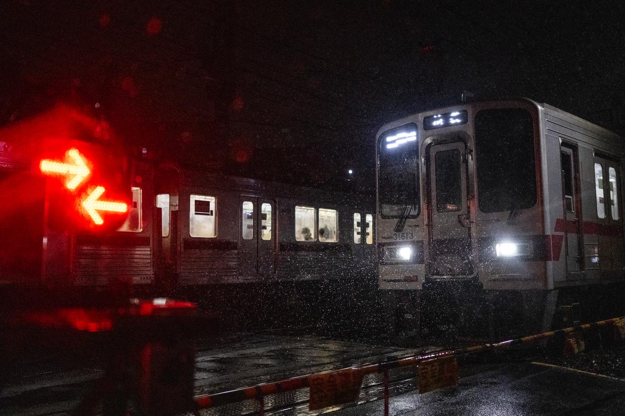 Trains cross during a heavy rainstorm in Tokyo on September 6, 2026. (AFP Photo)