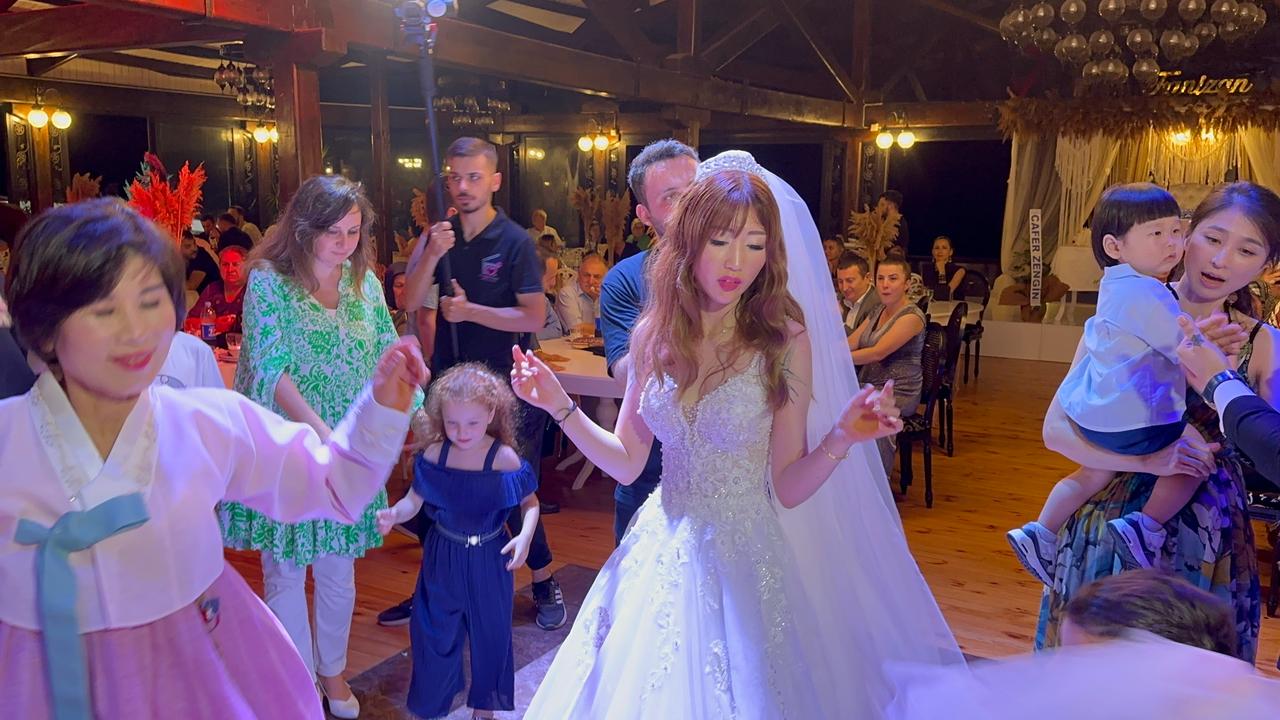South Korean bride Chaerin Han dances with guests during her wedding celebration after marrying Turkish national Tunahan Gultekin in Fatsa, Ordu, Türkiye, Aug. 12, 2023. (IHA Photo)