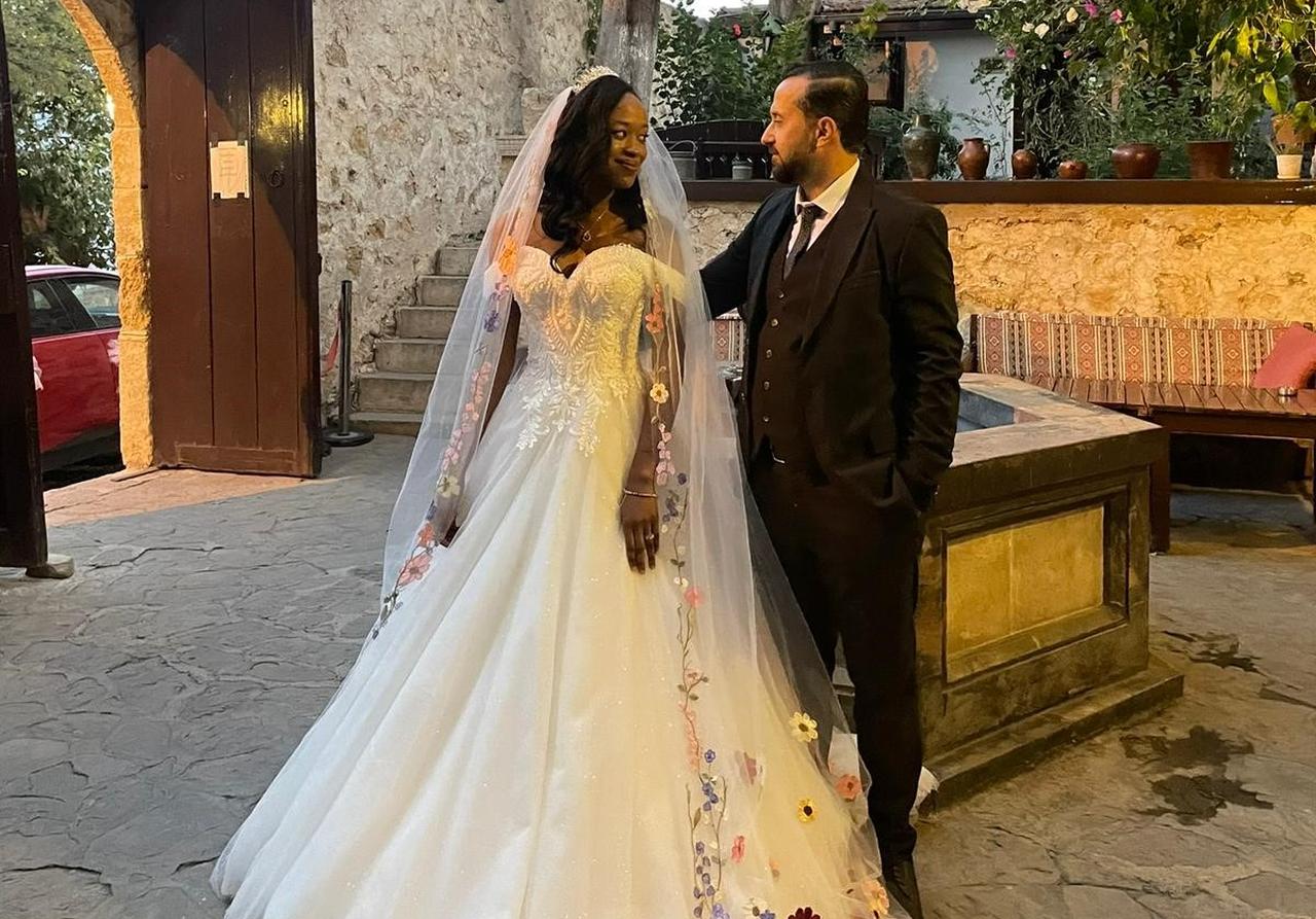U.S.-based African bride Rama Diallo and Turkish groom Halil Ibrahim Topal pose during their wedding celebration in Kozan, Adana, Türkiye, Dec. 6, 2025. (IHA Photo)