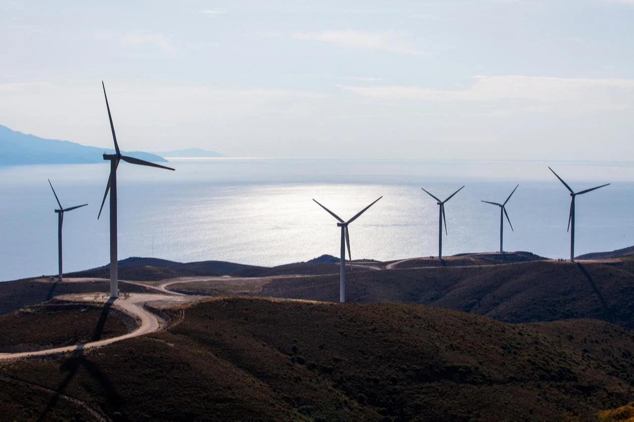 Wind turbines operate along a coast in Türkiye. (Adobe Stock Photo)