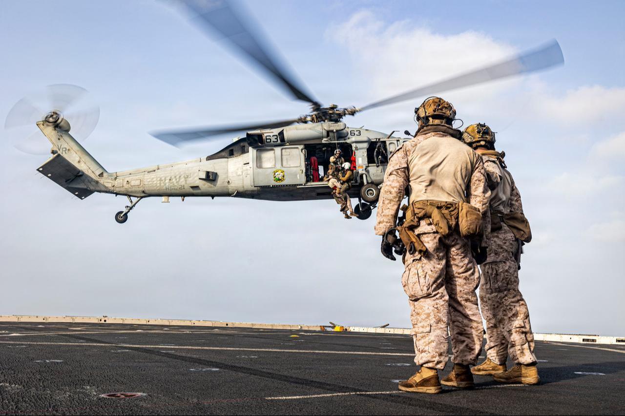 U.S. Marines conduct hoist training with an MH-60S Sea Hawk on the flight deck of San Antonio-class amphibious transport dock ship USS Portland (LPD 27) in the U.S. Central Command area of responsibility, Aug. 17, 2026. (Photo via U.S. Marine Corps)