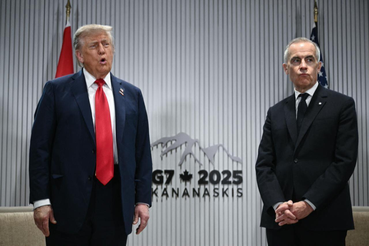 (L/R) US President Donald Trump speaks to the press as Canadian Prime Minister Mark Carney looks on as they meet during the Group of Seven (G7) Summit at the Pomeroy Kananaskis Mountain Lodge in Kananaskis, Alberta, Canada on June 16, 2025. (AFP Photo)