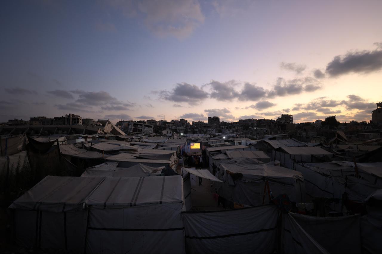 Palestinian children gather between the tents for an outdoor cartoon screening as part of the Little Wings Cinema mobile initiative, at a camp for people displaced by the war in Gaza City, Sept. 5, 2026. (AFP Photo)