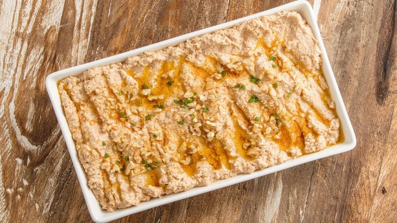A richly textured serving of cerkez tavugu topped with walnuts, herbs and seasoned oil. (File Photo)