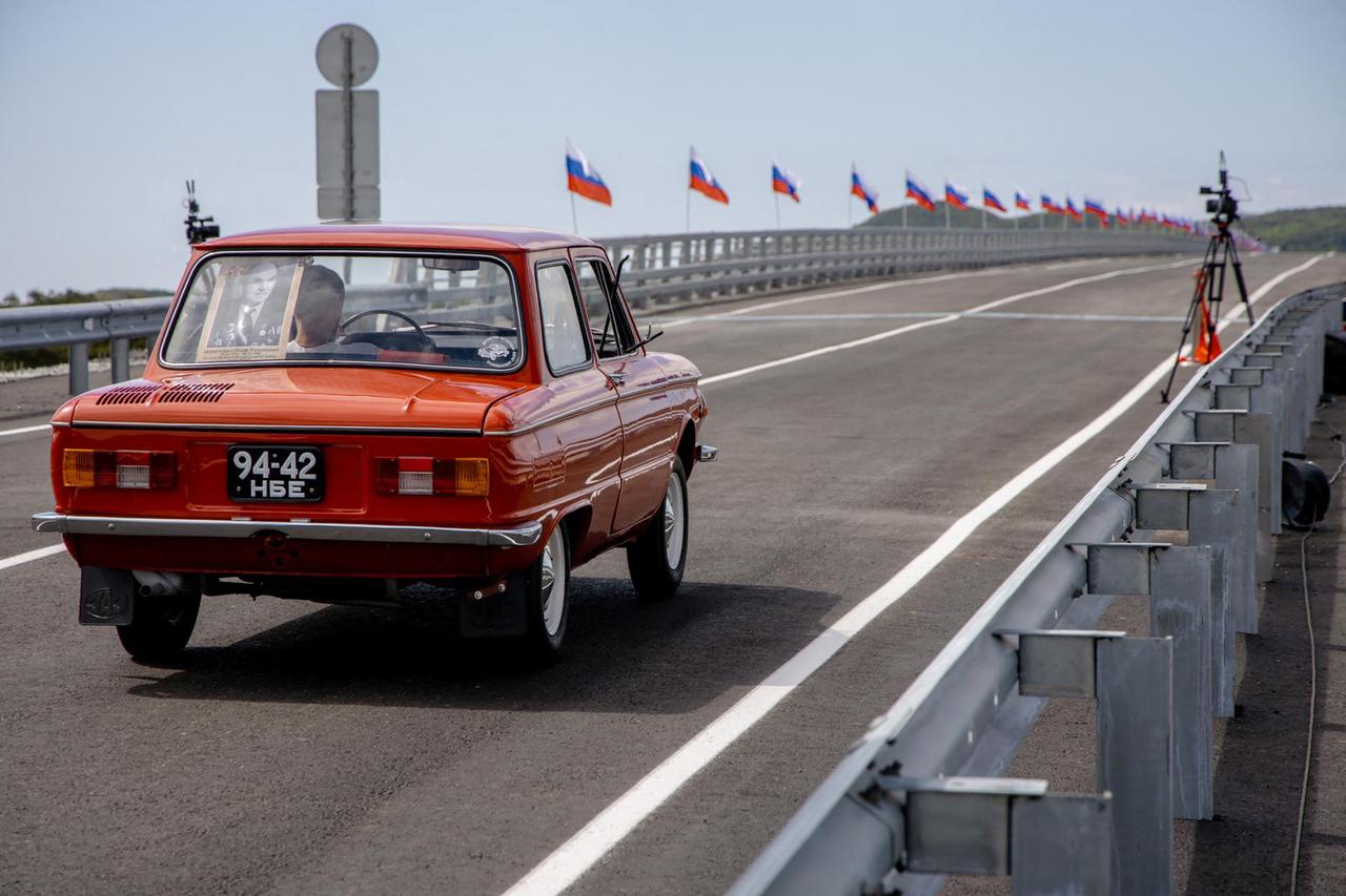 In this handout image released by the Russian Transport Ministry on September 7, 2026, a Zaporozhets car crosses the new Russia-North Korea road bridge over the Tumen River, during the opening ceremony. (Photo by Handout / Russian Transport Ministry / AFP)