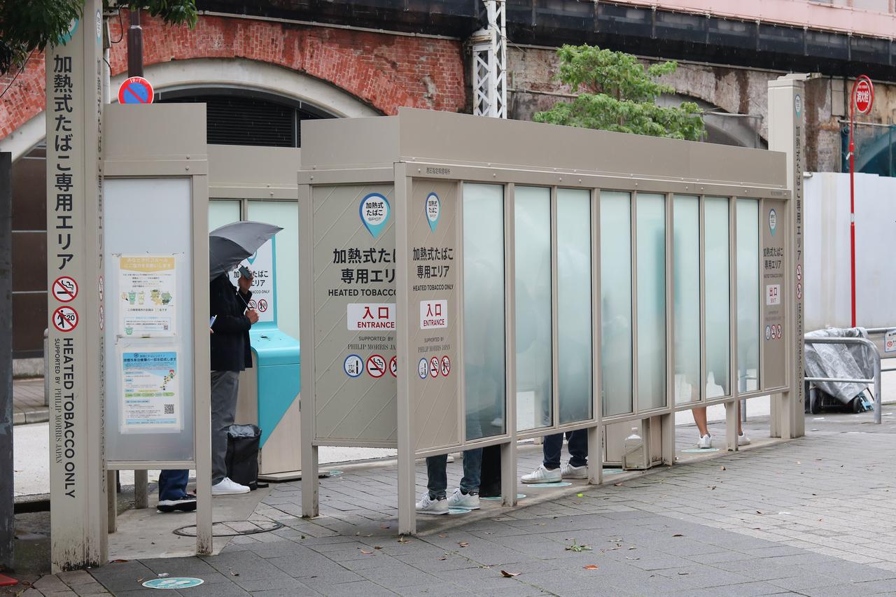People use a designated heated tobacco smoking area in Japan. (Adobe Stock Photo)