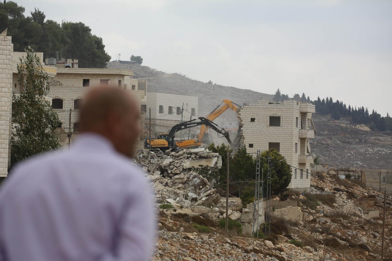 An excavator demolishes a Palestinian-owned building as Israeli forces carry out a raid in the Taawun Alawi area of Nablus, West Bank, Palestine on August 31, 2026. (AA Photo)