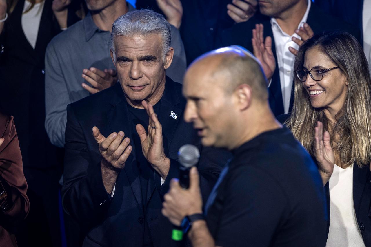 Former Israeli prime minister and opposition leader Yair Lapid (C) applauds as former Israeli prime minister Naftali Bennett speaks during a B'Yachad (Together) party while they present their candidates ahead of Israel's legislative elections in Tel Aviv on September 6, 2026. (AFP Photo)
