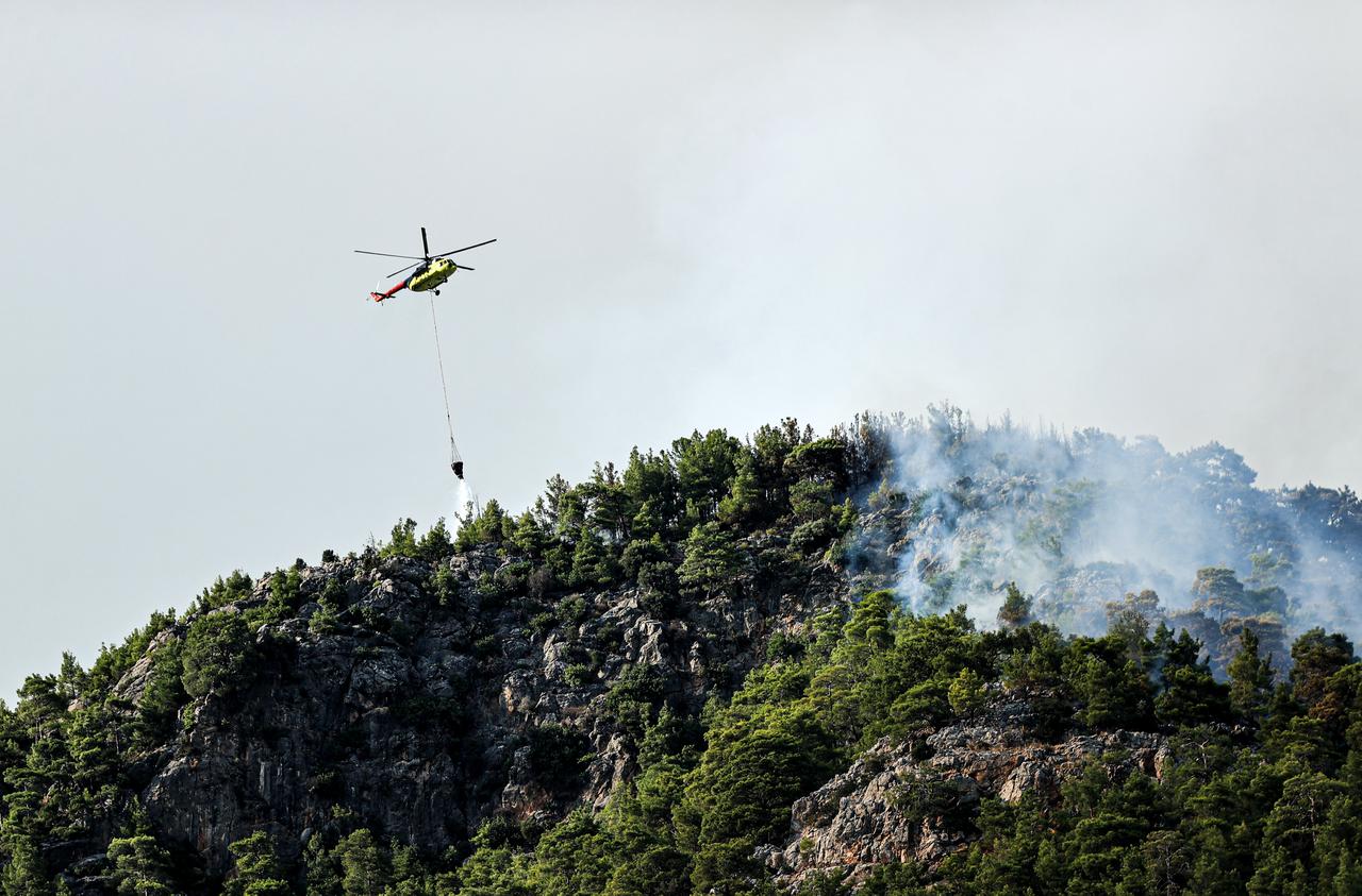 Firefighting teams work from the air and ground to extinguish a forest fire in the Bozyazi district, with 2 aircraft, 5 helicopters, 66 ground vehicles and 230 personnel taking part in the operation in Mersin, Türkiye, on September 8, 2026. (AA Photo)