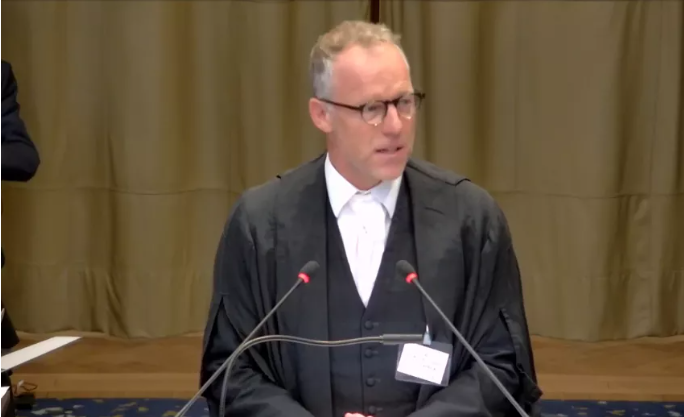 Professor Max Du Plessis, an international human rights law expert, gives the first speech after the hearing break.